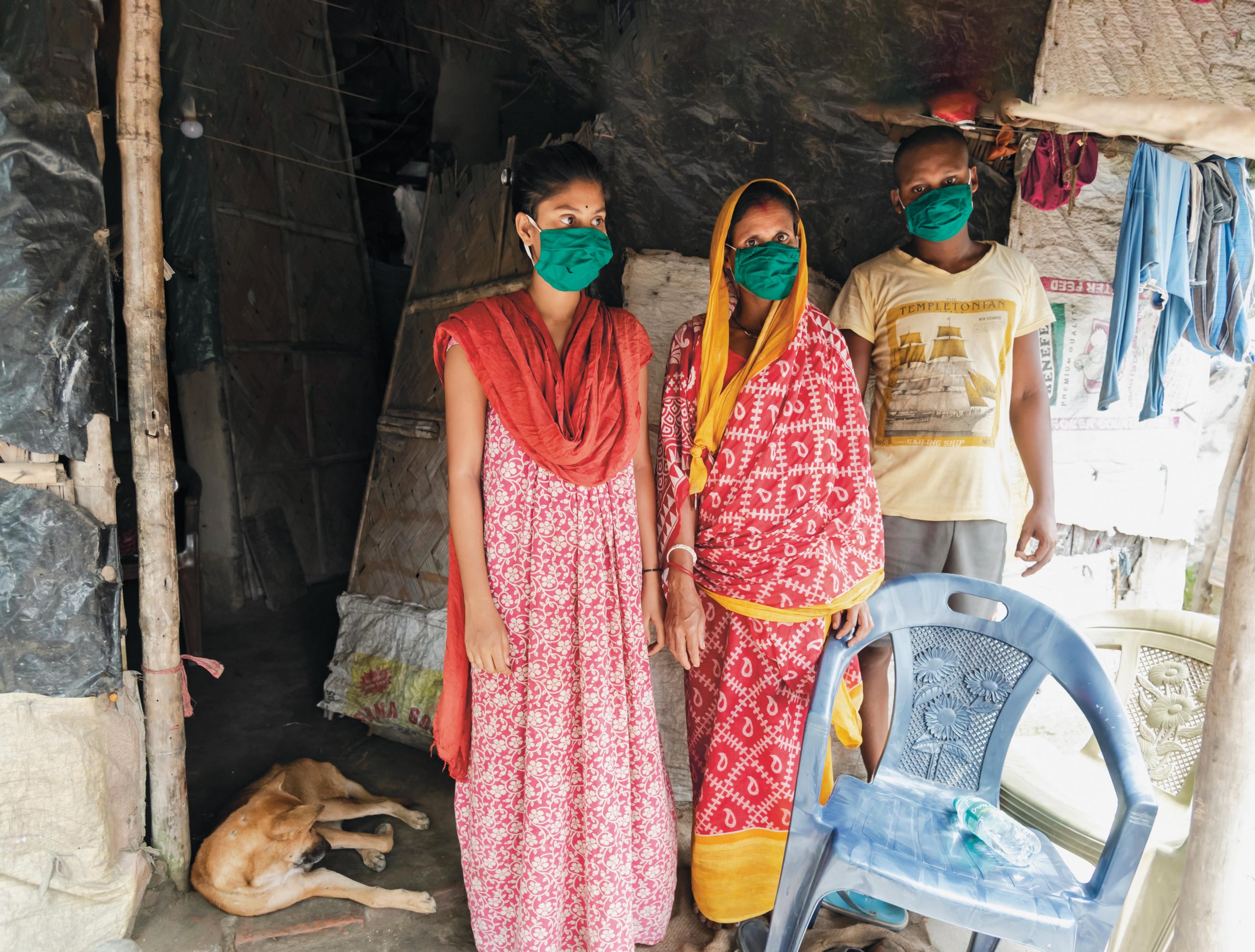 Three women wearing green face masks in India after Super Cyclone Amphan