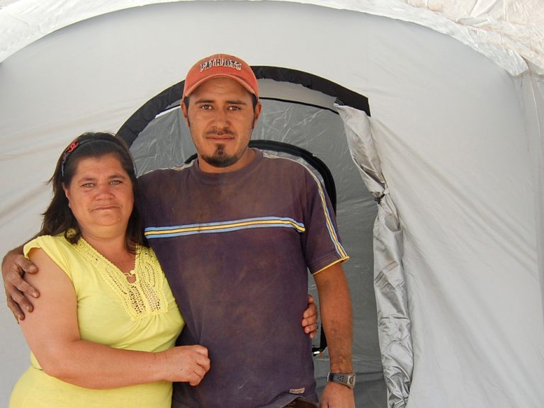 Man and woman standing outside a ShelterBox tent in Guatemala