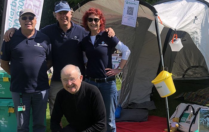 4 people outside a ShelterBox tent