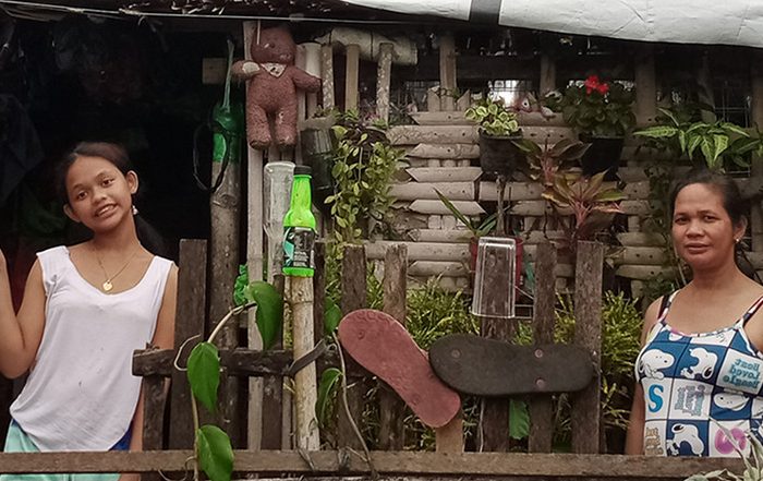 Two women outside a house in the Philippines