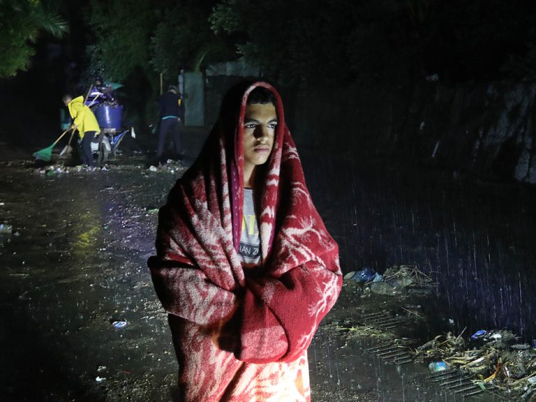 Man standing in rain during Storm Daniel in Libya