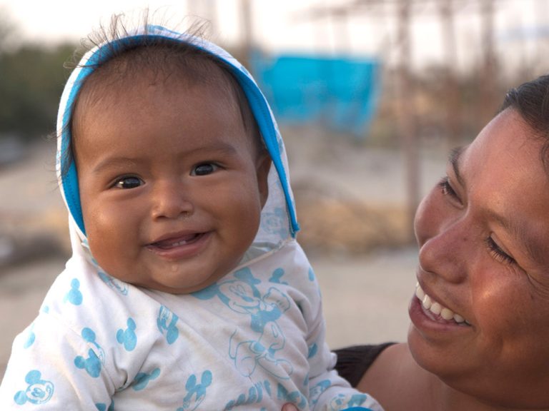 Woman holding her baby in Peru