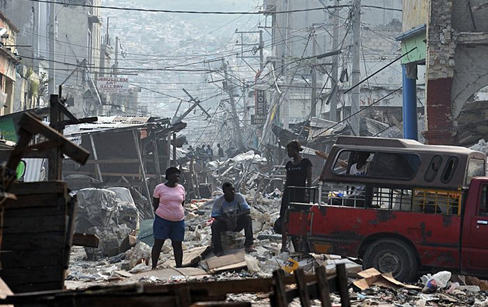 People among rubble after earthquake in Haiti