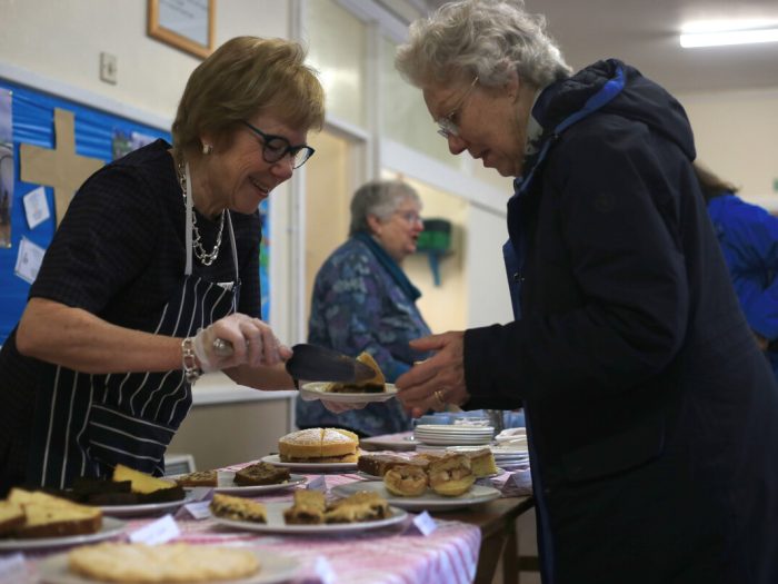 Person serving another at a coffee morning