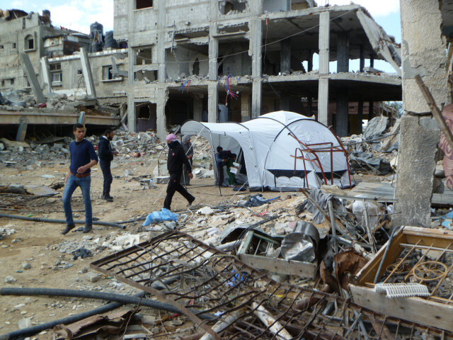 Tent among damaged buildings in Gaza