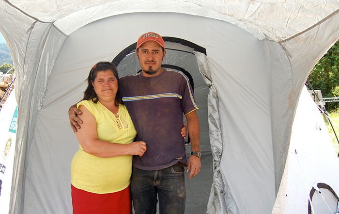 Man and woman standing outside a ShelterBox tent in Guatemala