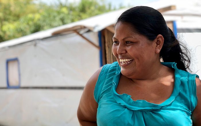 Woman wearing green top outside a shelter in Honduras