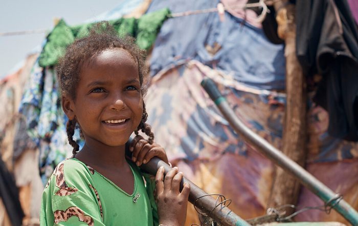 Little girl smiling outside a tent in Somaliland