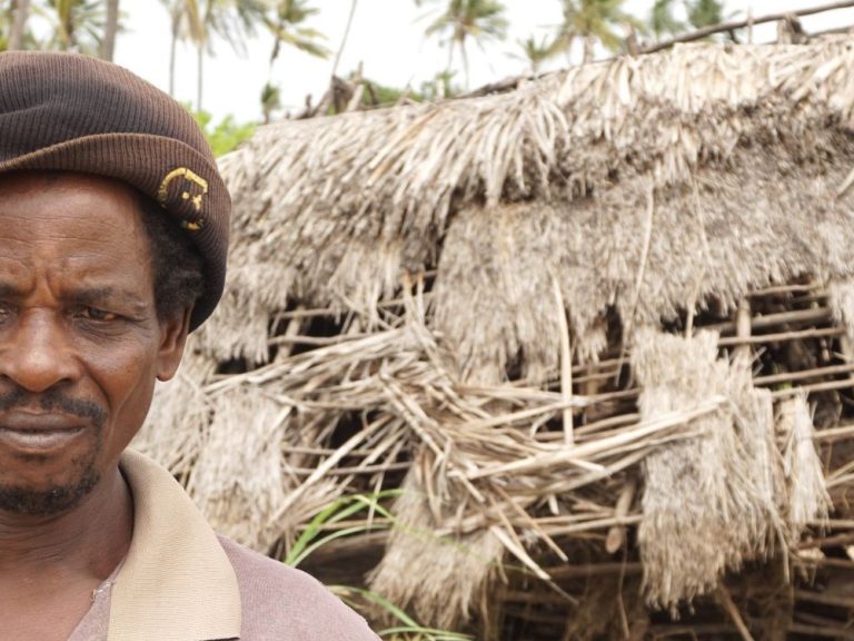 Man outside damaged shelter in Kenya