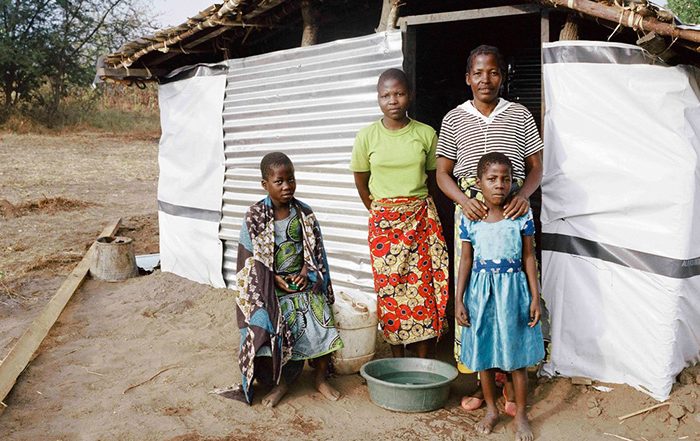 Family in front of a home in Malawi