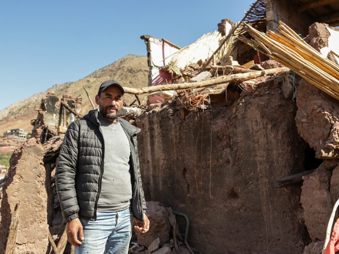 Man standing in destroyed home in Morocco