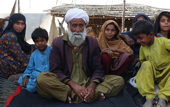 Family sitting on the ground in Pakistan