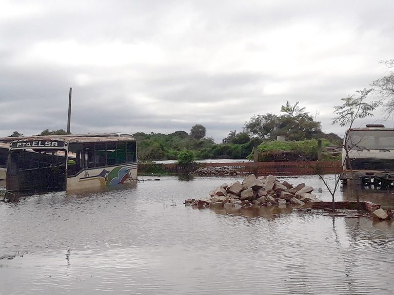 Flooded road and damaged buildings in Paraguay