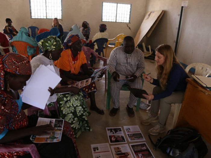 ShelterBox team member talking to people in a building in Cameroon