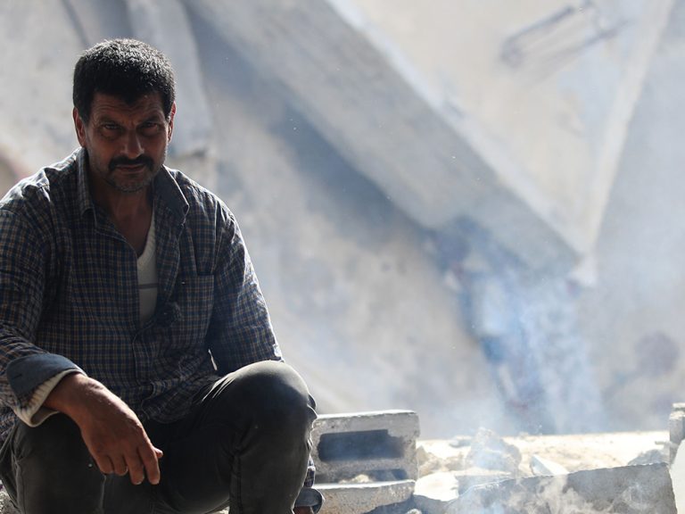 Man in damaged buildings in Gaza