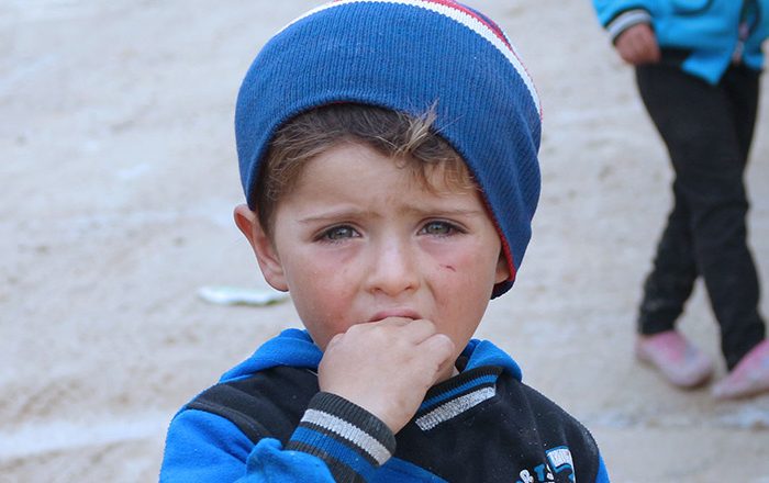 Little boy wearing a blue hat in Syria