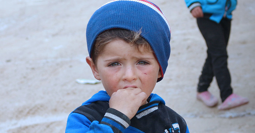 Little boy wearing a blue hat in Syria