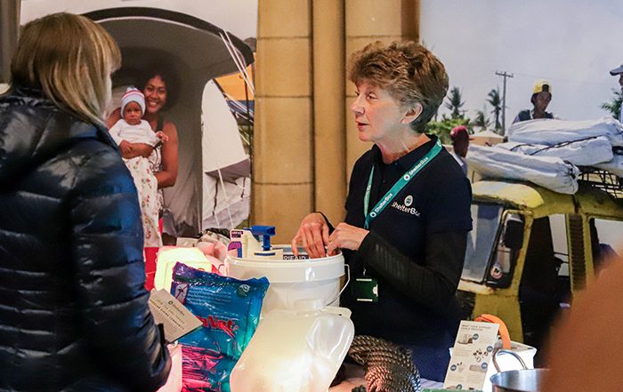 ShelterBox team member and member of public at a ShelterBox display in Truro cathedral