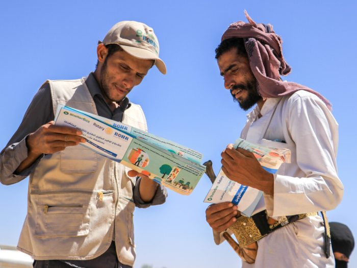 Two men in Yemen looing at a leaflet