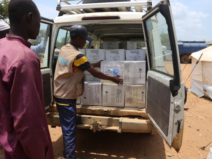 Men with boxes in van