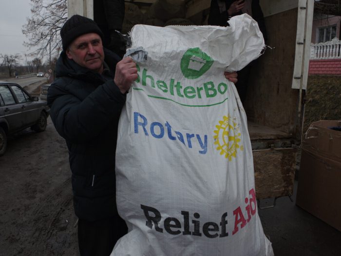 Man holding a bag of aid in Ukraine