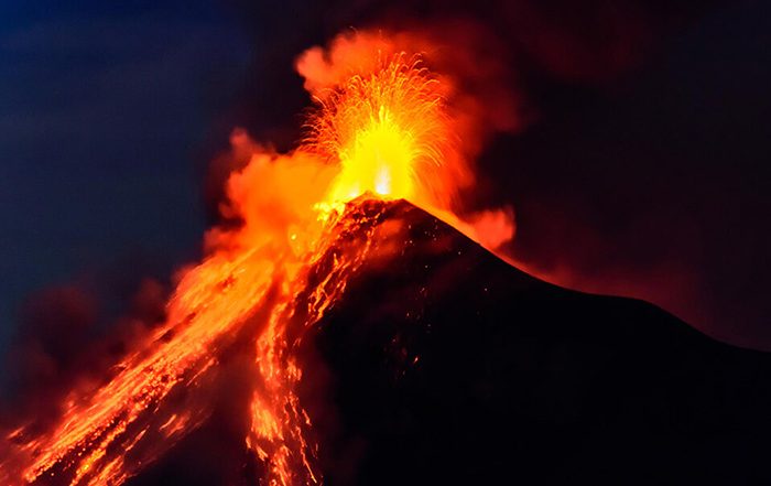 Volcano erupting at night