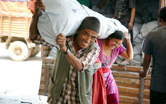 People carrying a shelter kit in Nepal