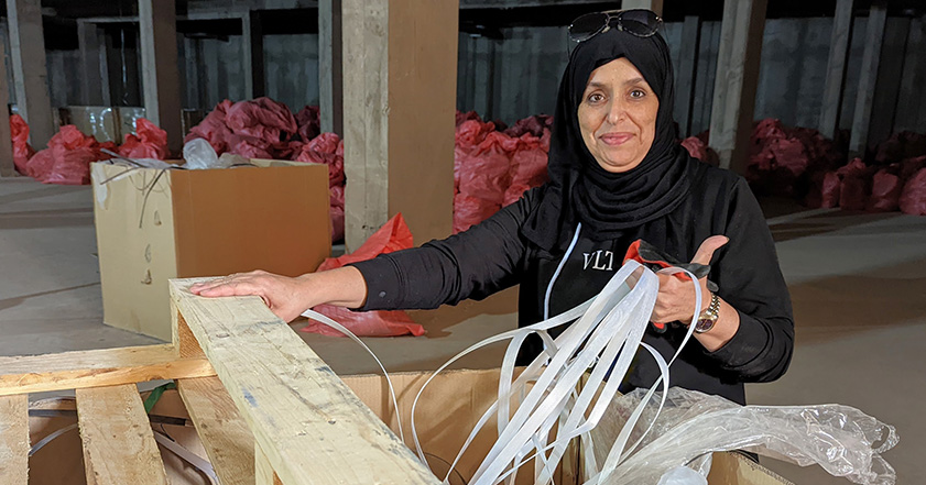 Woman with aid packaging in a warehouse in Morocco