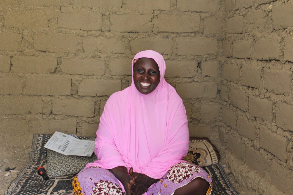 Woman sitting inside a brick shelter in Cameroon