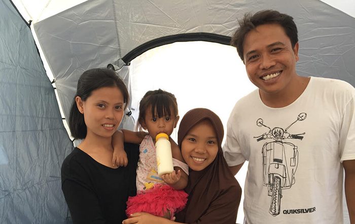 Family in Indonesia in a tent