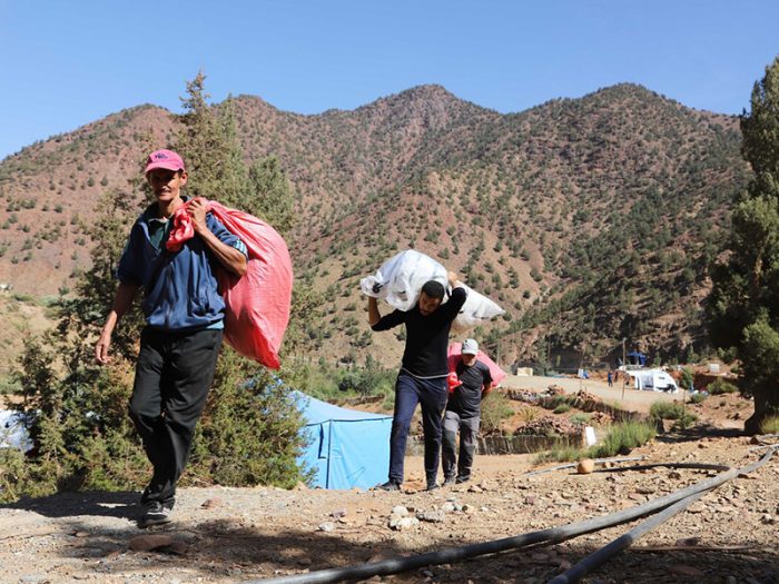 People carrying bags of aid in Morocco