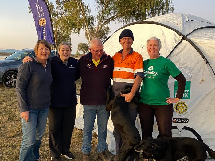 People standing outside a ShelterBox tent