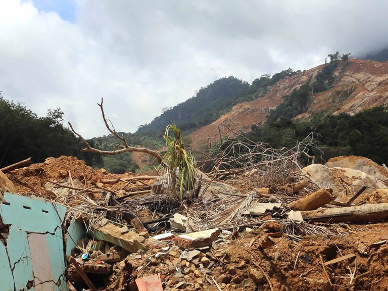 Hillside in Sri Lanka damaged by landslides and debris at the bottom of the hill