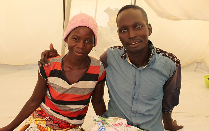 Man and woman sitting in a tent in Cameroon