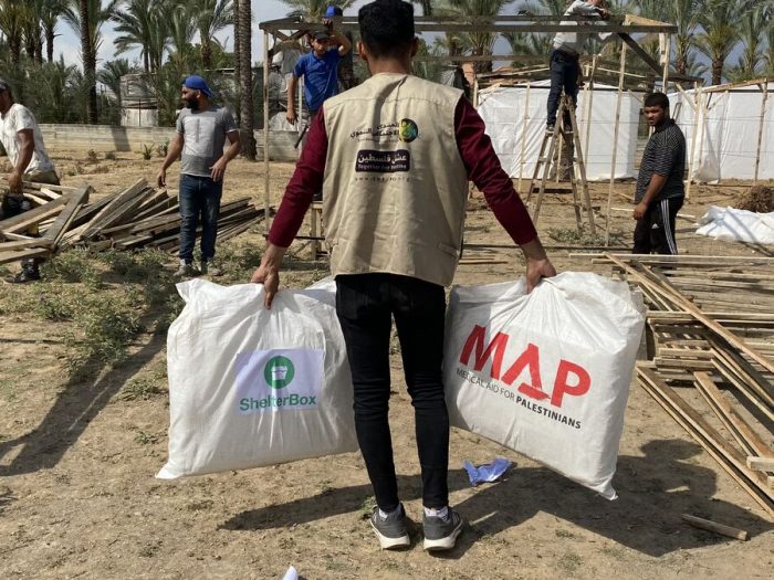 Man carrying bags of aid in Gaza