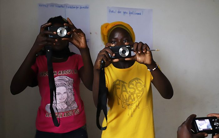 Two women pointing cameras towards the viewer