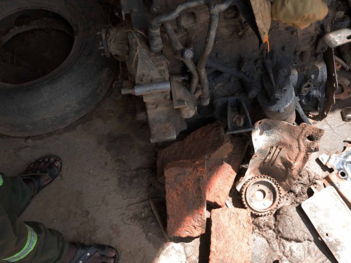 Damaged car parts on the floor in a garage