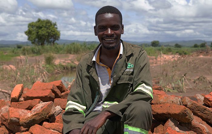 Man sitting on a pile of bricks in Malawi