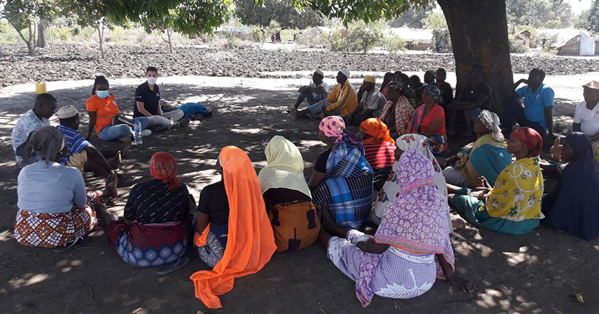 Group of people sitting on the ground in Mozambique