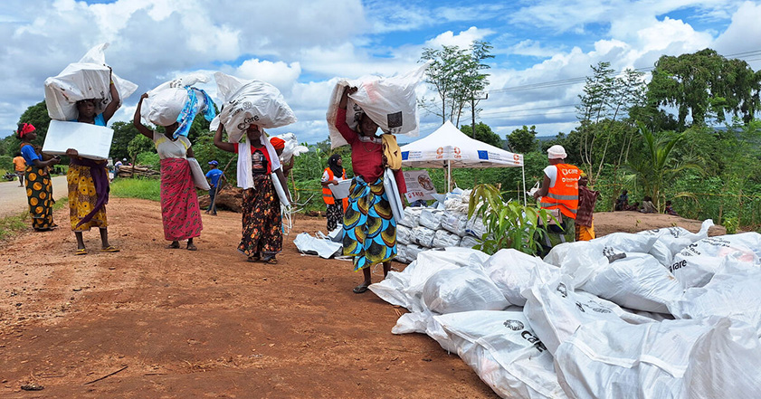 Women collecting bundles of aid waste in Mozambique