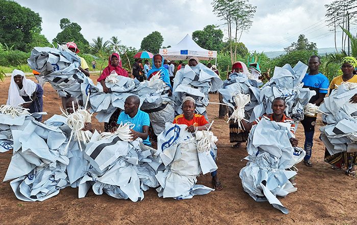 People holding waste from aid materials in Mozambique