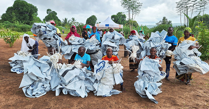 People holding waste from aid materials in Mozambique