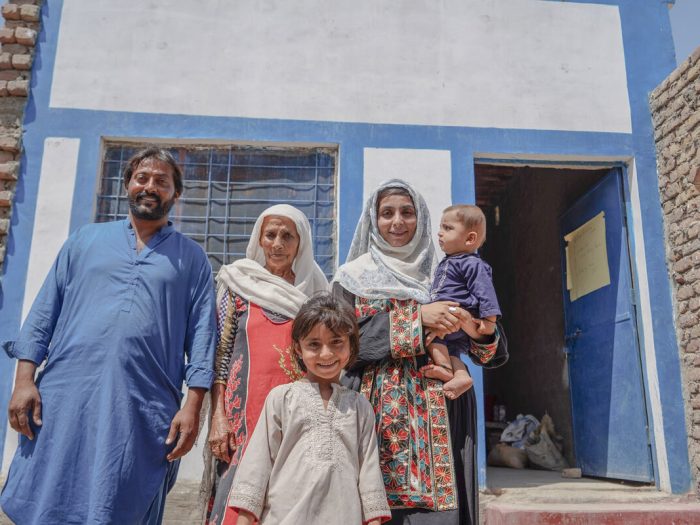 Two women, a man and 2 children outside a home in Pakistan