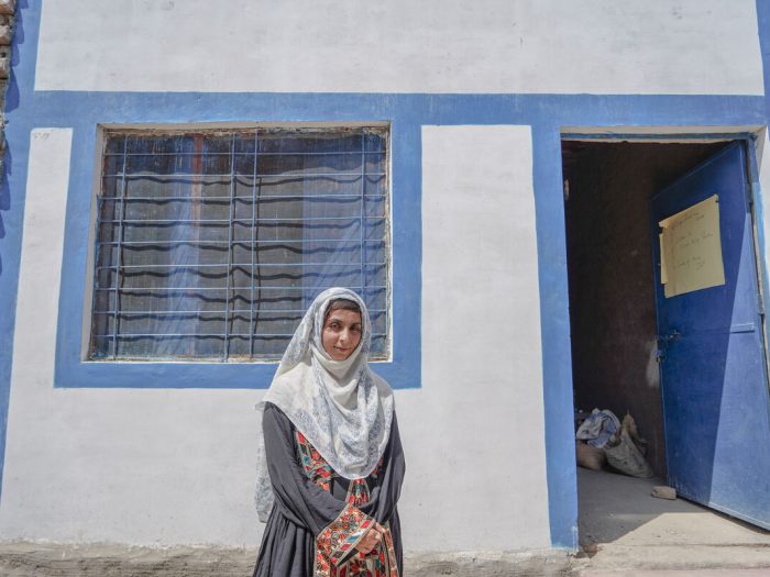 Woman standing outside a home in Pakistan