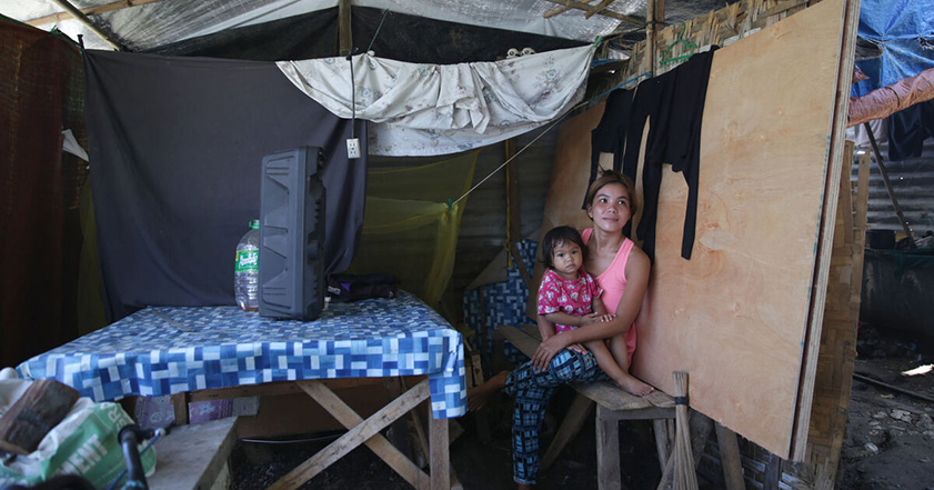 Woman and child sitting in a temporary shelter in the Philippines