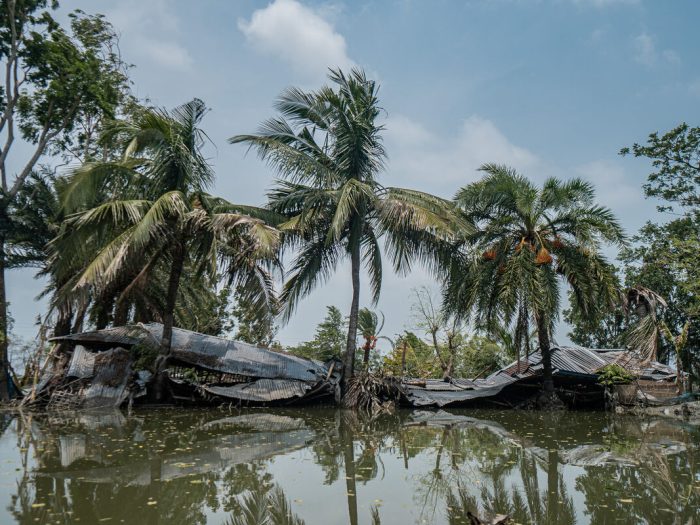 Collapsed buildings next to floodwater in Bangladesh