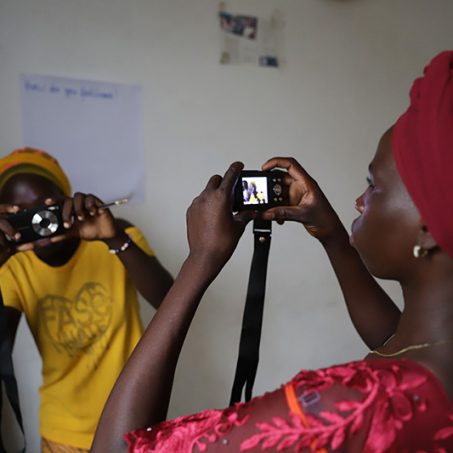 Women pointing cameras at eachother