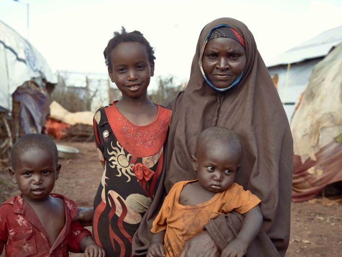 Woman and three children among shelters in Somalia