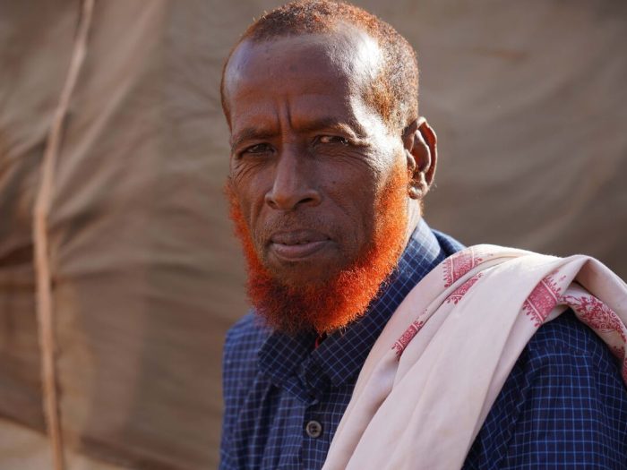 Man wearing blue looking at camera