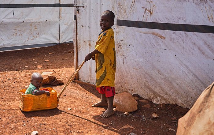 Boy pulling a younger child in a box